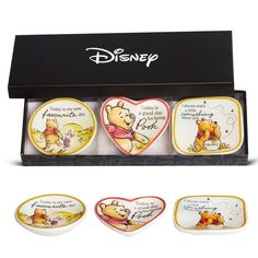 three winnie the pooh dishes in a box with two heart shaped plates on each side