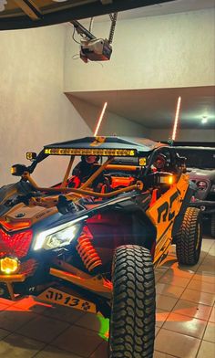 an orange and black four wheeled vehicle on display