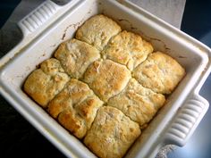 a square casserole dish filled with biscuits