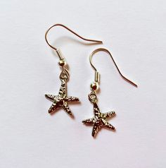 silver starfish earrings | perfect gift for someone who loves the beach! - select style: 2" chain, 1" chain, or no chain - the chain is silver plated - the starfish is silver plated, 12x13 mm - silicone earring backs Matching necklace (not included) shown in the 7th photo listed here: https://www.etsy.com/listing/1761083009/silver-plated-chain-y-necklace-with Matching bracelet (not included) shown in the last photo listed here: https://www.etsy.com/your/shops/me/listing-editor/edit/1746880550 💌 Summer Starfish Charm Star-shaped Jewelry, Summer Starfish Charm Star Shaped Jewelry, Summer Star-shaped Starfish Charm Jewelry, Silver Starfish Charm Jewelry For Summer, Silver Jewelry With Starfish Charm For Summer, Silver Star Earrings For Summer, Sterling Silver Starfish Earrings, Nickel Free Starfish Jewelry For Summer, Nickel Free Silver Starfish Earrings