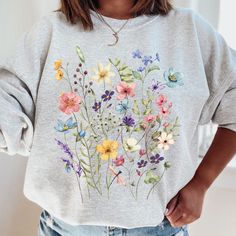 Our wildflower sweatshirt makes a perfect gift for your teacher,mom,wife,friend and of course yourself! -These sweatshirts are Unisex Adult Sizing (not women's fitted sweatshirt ). If you're going for a more fitted look, we suggest to size down.Please use the measurements chart in the pictures section to determine your correct size. -Props used In photos  are NOT included with purchase. -Care Instructions: Wash inside out in cold water, gentle cycle, tumble dry low or let air dry. Do not iron on design. If you have any questions, please contact me and I will be happy to answer. Please note that due to lighting effects, monitor's brightness, contrast and other settings, there might be some slight differences in the color tone/shade of the website's photo and the actual item. Thank you for v Wildflower Sweatshirt, Measurements Chart, Sweatshirt Aesthetic, Flower Sweatshirt, Teacher Mom, Ladies Shirts, Garden Lovers, Flower Shirt, Color Tone