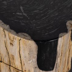 a wooden table with black marble top and silver metal frame around the edge is shown in close up view