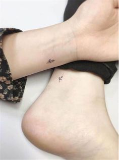 two small tattoos on the legs, one with an arrow and another with a bird