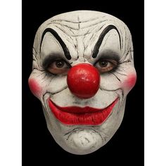 a close up of a clown's face with red nose and white makeup on black background