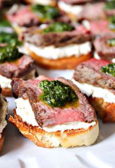 small appetizers with meat, cheese and sauces on them sitting on a white plate