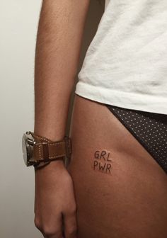 a close up of a person's stomach with the word girl pwr on it