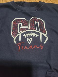 a t - shirt that says go texas with a football in the center and hearts on it