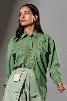 Fern green oversized shirt with scalloped collars patched pockets and front buttons.
Component: 1
Pattern: Plain
Neckline: Collar
Sleeve Type: Cuff Hem Sleeves
Fabric: 80% Polyester, 20% Cotton
Color: Green
Other Details: 
Scalloped hem collar
Oversized silhouette
Front button down
Note: The skirt and sling bag worn by the model is not for sale
Occasion: Party, Work - Aza Fashions Green Lapel Collar Shirt For Work, Green Shirt With Casual Collar And Pockets, Green Shirt With Pockets And Casual Collar, Green Workwear Tops With Flap Pockets, Green Tops With Flap Pockets For Work, Green Top With Lapel Collar And Pockets, Green Tops With Lapel Collar And Pockets, Green Tops With Pockets And Lapel Collar, Chic Shirt With Pockets And Lapel Collar