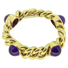 Here we have a fabulous statement bracelet. Crafted from a warm 18ct yellow gold, this vintage piece showcases wide heavy flat curb links collectively weighing an impressive 96.0 grams whilst playing host to four round cabochon amethysts; each of which sits in an individual bezel setting and possesses a rich deep purple colour tone Condition: Used (Very Good) Weight: 96.0 grams Bracelet Length: 7.8 inches Bracelet Width: 17mm Amethyst Dimensions: 4 (8mm) Fastening: Double Latched Tab Insert Mark Luxury Vintage Purple Bracelet, Luxury Vintage Purple Bracelets, Deep Purple Color, Vintage Sapphire, Purple Colour, Gold Box, Amethyst Bracelet, Statement Bracelet, Vintage Bracelets