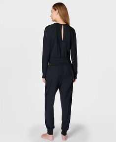 Our new-and-improved jumpsuit for low-impact workouts. Updated 85% recycled fabric is ultra-soft, smooth and sweat-wicking. Loose fit with V-neck and long sleeves. Fitted waistband, cuffs and ankles to stay put as you move. Inseam length: 73cm / 29”. Model wears size S and is 178cm/5'10" tall. Style Code: SB9727Colour: Black Athleisure Long Sleeve Jumpsuits And Rompers With Thumbholes, Stretch Athleisure Jumpsuits And Rompers For Fall, Stretch Jumpsuits And Rompers For Fall Athleisure, Fall Stretch Jumpsuits And Rompers In Athleisure Style, Fall Athleisure Stretch Jumpsuits And Rompers, Long Sleeve Activewear With Elastic Waistband In Athleisure Style, Athleisure Long Sleeve Jumpsuits For Loungewear, Sporty Long Sleeve Jumpsuits And Rompers For Loungewear, Sporty Elastane Jumpsuits And Rompers For Loungewear