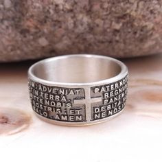 "Band ring with engraved prayer \"Our Father\" in Latin Features Material: silver Metal title: 925 Weight: gr. 7,50 Engraved prayer: Our Father in Latin Warranty: Gioielli Aurum Color: silver Subject: New Product code: aneb128_arg Various sizes available. Hypoallergenic - DOES NOT darken. The Jewel is new and is shipped insured by express courier, in gift box with warranty included. All our jewels are punched with the precious metals brand and the trademark. Watch the video of this ring at: http Symbolic Engraved Ring Stamped 925 For Promise, Spiritual White Gold Ring Stamped 925, Adjustable Silver Rings For Commemoration, Symbolic Sterling Silver Engraved Ring For Commemoration, Symbolic Silver Ring For Commemoration, Sterling Silver Commemoration Rings, Sterling Silver Spiritual Promise Ring, Sterling Silver Commemorative Round Rings, Sterling Silver Cross Ring For Promise