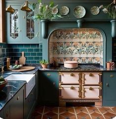 an old fashioned kitchen with green cabinets and blue tile backsplash, potted plants on the stove