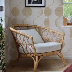 a wicker chair sitting in front of a window