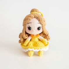 a crocheted doll wearing a yellow dress