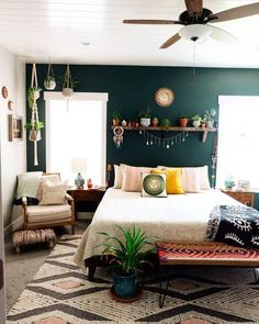 a bed room with a neatly made bed next to a window and a ceiling fan