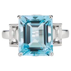 Inspired by the sparkling hues of the Mediterranean Sea, this elegant ring from the Andalusian Collection features a stunning natural sky blue topaz surrounded by two dazzling white topaz baguettes, set in 9ct white gold. The Andalusian-inspired luxury jewellery London designed collection takes inspiration from Hispano-Moorish architectural styles of the enchanting southernmost region of Spain. The gemstone jewellery from this collection designed by British Jewellers boasts vibrant yet sophisticated combinations of natural-coloured gemstones with precious metals. Our luxury gemstone jewellery piece, the Octagon White Gold Ring in White Topaz & Blue Topaz octagon-cut central stone measures 12x10mm and side stones baguettes measure 6x3mm. The gemstones are set in a luxurious Solid 9ct White Custom Gold Jewelry, Coloured Gemstones, Emerald Cut Ring, Topaz Birthstone, Ring Emerald Cut, White Topaz Rings, Emerald Cut Rings, Architectural Styles, Luxury Jewellery