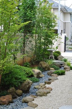 a garden with rocks and trees in it