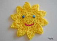 a yellow crocheted sunflower with blue eyes