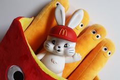 mcdonald's stuffed animals are sitting next to some hotdog buns with eyes on them