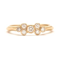 a gold ring with three diamonds on it