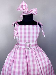 AVAILABLE IN KNEE LENGTH - MESSAGE FOR DETAILS Carefully hand stitched together with the upmost care, this dress will make the perfect unique Halloween costume! Beautifully handcrafted doll move inspired pink and white plaid dress; A sleek top with spaghetti straps that can be tied and untied to adjust the length of the straps. Comes with a detachable belt with faux pearls and a matching hair bow. Hidden zipper can be found on the side of the dress. Dress goes down to ankle/calf.  It is great fo Pink Dress For Halloween Dress-up, Pink Sleeveless Dress For Halloween, Summer Pageant Purple Dress, Purple Summer Pageant Dress, Summer Purple Pageant Dress, Pink Princess Dress For Halloween, Pink Dresses For Halloween Dress-up, Pink Fitted Princess Dress For Halloween, Sleeveless Princess Dress For Spring Costume Party