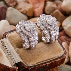 These captivating "J" style earrings are each centered with a pear brilliant cut diamond in a five-prong setting. The earrings are accented with fourteen (14) round single cut diamonds and thirteen (13) round brilliant cut diamonds in bead settings. The earrings measure 22.0mm long by 16.1mm wide and 19.3mm deep, finished with posts and omega backs. Luxury Marquise Platinum Diamond Earrings, Formal White Gold Diamond Clip-on Earrings, Luxury Pear-shaped Cluster Earrings With Brilliant Cut, Luxury Platinum Cluster Earrings In Diamond White, Luxury Diamond White Platinum Cluster Earrings, Marquise Single Cut Diamond Earrings For Formal Events, Luxury Cluster Diamond Earrings With Single Cut Diamonds, Marquise Single Cut Diamond Earrings For Formal Occasions, Brilliant Cut Marquise Diamond Earrings For Formal Occasions