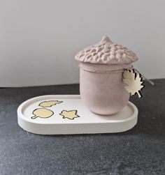 a ceramic cup sitting on top of a tray