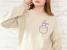 "Happy Easter Bunny Shirt, Cute Easter Rabbit, Adorable Animal Lover Gifts for Women, Easter Day Sweatshirts for Her, Pocket Shirt for Friend Looking for Happy Easter Bunny Shirts?🐰💐 Then the Easter Bunny Shirts are perfect for you! The Pocket Shirts will also be Adorable Bunny Gifts for Friends & Family who love Bunnies. Get the Easter Day Sweatshirts now❤️ 💛Related Items💛 🫧Happy Easter Bunny Sweatshirt https://www.etsy.com/listing/1413224902/bunny-shirt-easter-sweatshirt-bunny 🫧Easter Bunny Sweatshirt https://www.etsy.com/listing/1406805537/happy-easter-bunny-shirt-cute-easter 🫧HipHop Easter Bunny Sweatshirt https://www.etsy.com/ca/listing/1415693896/bunny-shirt-easter-sweatshirt-bunny 🫧Happy Easter Gnome Sweatshirt https://www.etsy.com/ca/listing/1430723261/happy-easter-gnomies- Kawaii Crew Neck Top, Kawaii Crew Neck Tops As Gift, Kawaii Crew Neck Tops For Gifts, Cute Bunny Design Crew Neck T-shirt, Cute Long Sleeve T-shirt As Gift, Cute Crew Neck Top With Bunny Design, Cute Long Sleeve Tops As Gift, Cute Long Sleeve Tops As A Gift, Cute Graphic Print Sweatshirt For Gift