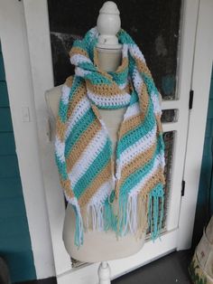 "This handmade crocheted deluxe scarf is made with diagonal stripes of aqua, beige, & white. It is 62\" in length and 7\" wide. the fringe adds an additional 5\" per side. It is one of a kind, made in a smoke free home." Bohemian White Hand Knitted Scarves, White Bohemian Hand Knitted Scarves, Bohemian White Hand Knitted Scarf, Bohemian White Hand-knitted Scarf, White Crochet Bohemian Scarves, White Bohemian Crochet Scarves, Boho Scarf, Boho Scarfs, Grey Clouds