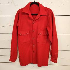 "Vintage red wool shirt jacket. Originally a Boy Scouts Jacket. Tag has been cut out. Excellent condition. Does have some slight discoloration on the back and around the cuff. Missing very top button. Fits like a large roughly 42L 22\" pit to pit  18\" shoulder to shoulder 33\" shoulder to hem 26.5\" shoulder to cuff B09" Red Long Sleeve Outerwear With Button Cuffs, Wool Button-up Top For Winter, Collared Wool Outerwear With Snap Buttons, Red Winter Outerwear With Button Cuffs, Vintage Outerwear With Button Cuffs, Vintage Long Sleeve Outerwear With Button Cuffs, Red Lapel Collar Outerwear With Buttons, Red Outerwear With Lapel Collar And Buttons, Vintage Solid Color Button-up Outerwear