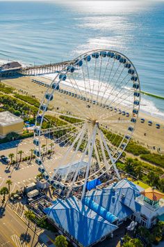 an aerial view of a ferris wheel on the beach