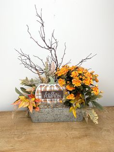 an arrangement of flowers in a metal container