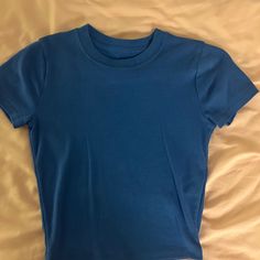 Never Worn Blue Stretch Crew Neck Top, Blue Fitted Cotton T-shirt, Fitted Blue Cotton T-shirt, Trendy Blue Cotton Top, Trendy Fitted Blue Tops, Fitted Blue T-shirt For Summer, Fitted Blue Cotton Top, Light Blue Stretch Tops With Solid Color, Blue Fitted Crew Neck T-shirt