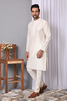 Description: Elevate your ethnic wardrobe with Richart's Men's  White Jacquard Silk Kurta Pyjama, the epitome of quality and affordability. Since 2015, Richart has been committed to maintaining superior standards in every piece, ensuring you always look your best. Exquisite Design and Fabric: This standout kurta features a stylish self-design crafted from luxurious Jacquard silk, paired with a silk blend churidar pyjama. The vibrant green kurta and classic white pyjama make an eye-catching combination perfect for any special occasion. Perfect for Special Occasions: Ideal for weddings, festivals, and parties, this ensemble can be effortlessly paired with embroidered mojris to complete your traditional look. Product Details: Style: Zari Jacquard Silk Kurta with Off-White Silk Blend Churidar Luxury Classic White Kurta, Luxury White Jamawar Kurta, White Kurta Set, Occassion Dress, Mens Ethnic Wear, Wedding Kurta, Kurta Men, White Pajamas, Kurta Pyjama