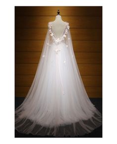 a white wedding dress with flowers on it