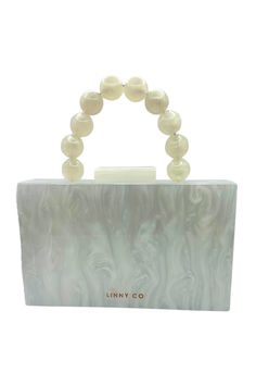 The LINNY CO Cecelia clutch is an exquisite fashion statement. Comes with a 4 inch beaded handle and a gold-plated crossbody strap. Engraved with the LINNY CO brand. Material: Acrylic; Color: Pearl White; Fabric Lined; Fits an iPhone 14, card case, lipstick and single key; Magnetic Closure; Size of bag exclusive of the handle: 18x11x4.5mm; Handle with care. Chic Beaded Evening Bag With Top Handle, Chic Beaded Top Handle Evening Bag, Elegant Pearl Handle Crossbody Evening Bag, Elegant Crossbody Evening Bag With Pearl Handle, Crossbody Evening Bag With Pearl Handle, Trendy White Evening Bag For Formal Events, Chic Clutch With Gold-tone Hardware For Events, White Handheld Clutch As Fashion Accessory, Chic Beaded Handheld Clutch