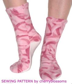 a woman's feet with pink and white socks that have zebra print on them