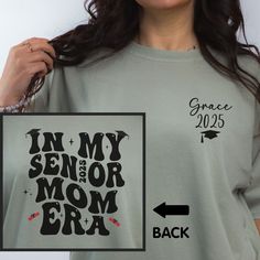 In My Senior Mom Era Comfort Colors T-shirt is the perfect shirt for the mom of a 2025 graduate! In the personalization box, enter the name and year of your senior for the front pocket personalization (Ex: Grace, 2024) This shirt runs true to size.  If you want an oversized look, please order one size up.  If you want the oversized dress look, please size up two sizes. Short Sleeve: This is made with a 1717 Comfort Colors, garment-dyed t-shirt. Made with 100% ring-spun cotton, soft-washed, and g Mom Of A Senior Shirt, Senior Living Tshirt, Senior Parent Night Outfit, Senior Mom Shirts 2025, Senior Mom 2025, Graduation Gift Short Sleeve T-shirt With Text Print, Short Sleeve Text Print T-shirt For Graduation, Graduation Gift Text Print T-shirt, School Spirit Tops With Letter Print For Graduation