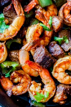 closeup of shrimp and steak stir fry in a skillet