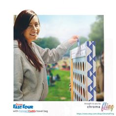 a woman is holding up a giant board game