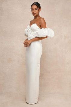 Ensure that your big day is truly unforgettable with a pristine look like the Lulus Profound Love White Satin Pleated Puff Sleeve Maxi Dress! Sleek woven satin lends a luxe essence to this gown that features a sweetheart-style neckline (with hidden no-slip strips) and a chic, pleated bodice with a surplice-inspired design, supportive padding, low-cut back, and side boning. The high, fitted waist tops a column skirt that falls to an elegant maxi hem with a flirty kick pleat at the back. If you're Elegant Taffeta Gown With Sweetheart Neckline, Taffeta Wedding Dress With Sweetheart Neckline, Wedding Taffeta Dress With Sweetheart Neckline, Wedding Dress With Sweetheart Neckline In Taffeta, Elegant Evening Dress With Fitted Bodice And Puff Sleeves, Elegant Taffeta Evening Dress For Wedding, Glamorous Satin Evening Dress For Debutante Ball, Taffeta Evening Dress With Fitted Bodice For Wedding, Taffeta Evening Dress With Sweetheart Neckline For Wedding