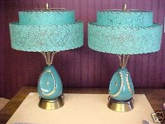 two blue lamps sitting on top of a table