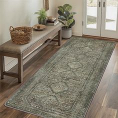 a large area rug with an ornate design on the floor next to a wooden bench