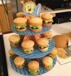 there are many cupcakes on the cake stand with spongebob characters on them