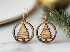 the wooden earrings are decorated with pine trees