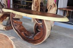 a wooden bench sitting on top of a cement floor