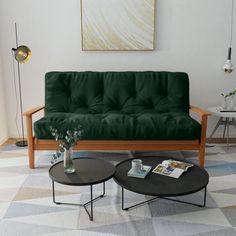 a living room with a blue futon couch and coffee table in front of it