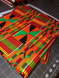 Ankara Fabric 100% cotton, Double-sided Material: 100% Cotton Width: 46"" The vibrancy and intensity of this piece is real, highly potent.  The colors just pop out!  This high quality Kente fabric is 100% cotton with intense hues of orange, red, black, and green.  A classic pattern, with a new zest and excellence.  Perfect for clothing, quilting, pillows or crafts, double sided and 46"" wide.  All Ankara is cut to order, and is sold by the yard.  African fabric is processed and folded on the app Cotton Fabric With Vibrant Multicolor Print, Multicolor Cotton Fabric With Vibrant Print, Vibrant Multicolor Cotton Fabric, Traditional Patterned Cotton Fabric For Festivals, Cotton Fabric With Vibrant Patterned Print, Patterned Cotton Fabric With Vibrant Print, Vibrant Print Patterned Cotton Fabric, Vibrant Print Cotton Fabric, Traditional Multicolor Cotton Fabric