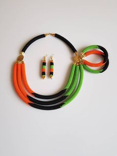 100% handcrafted using original fine beads. *Comes with matching earrings and 2 bracelets. The necklace is 18 inches long( round the neck). Each section is attached to one another nicely. S hook clasp is used for closure. **Buy multiple items and pay shipping for 1 item only.The rest ships free. More neckleces here; https://www.etsy.com/shop/TribalTess?ref=seller-platform-mcnav&section_id=21306083 Back to my shop; https://www.etsy.com/shop/TribalTess?ref=seller-platform-mcnav African Beaded Necklace, African Beads Necklace, Orange Necklace, African Necklace, Gold Bead Necklace, S Hook, African Beads, Black And Orange, Hook Clasp