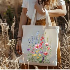 Elevate your style effortlessly with the Vintage Aesthetic Aquarel Flower Print Tote Bag This 100% cotton bag comes in one size - 15" x 16"- perfect for everyday wear. While the canvas material will show off your designs in great colors, it's durable and will last for years. The bag features 20" handles (made from the same canvas), making it easy to carry even with a week's worth of shopping. ☆ 100% cotton canvas ☆ Heavy fabric (12 oz/yd² (406.9 g/m ☆ Sewn-in label ☆ Available in natural and bla Gardening Gift, Canvas Making, Floral Bags, Bag Vintage, Black Tote, Garden Gifts, Vintage Aesthetic, Canvas Tote Bag, Printed Tote Bags